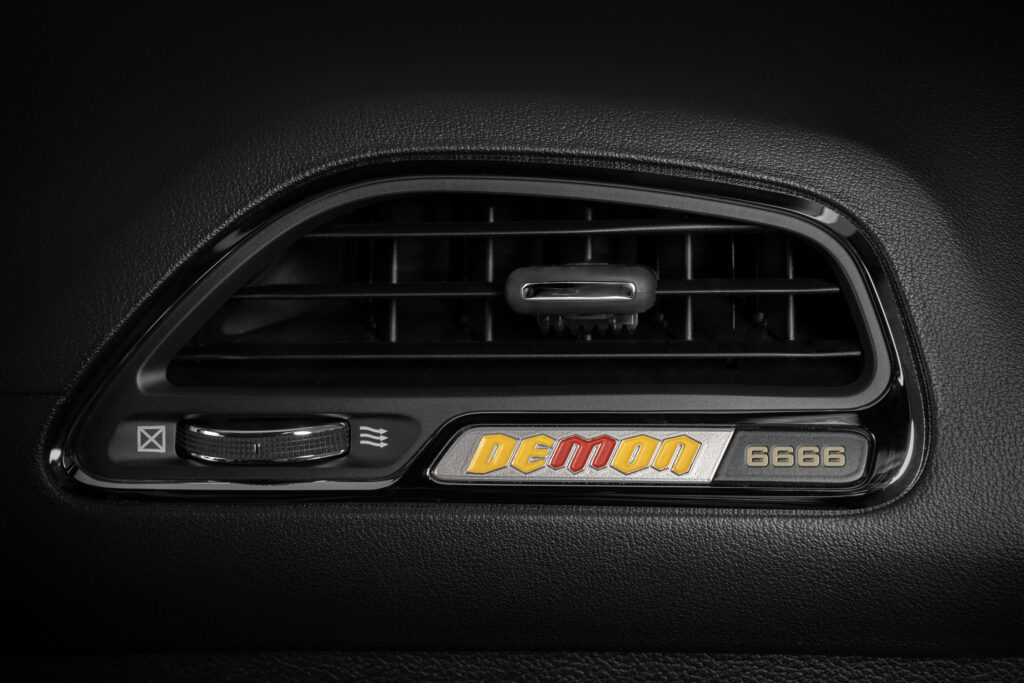 A yellow and red Demon instrument panel badge calls out the four